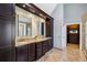 Bright bathroom featuring double sink vanity with granite countertop and wood cabinetry at 1562 Asheforde Dr, Marietta, GA 30068