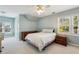 Spacious bedroom with two windows, ceiling fan, light blue paint, and carpet flooring at 1562 Asheforde Dr, Marietta, GA 30068