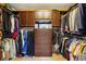 Walk-in closet with custom storage solutions, featuring built-in cabinets and clothes racks at 1562 Asheforde Dr, Marietta, GA 30068