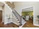 Elegant staircase with iron railings, hardwood floors, and trim details leading to the second floor at 1562 Asheforde Dr, Marietta, GA 30068