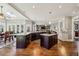 Open kitchen featuring stainless steel appliances, large island, and stylish pendant lighting at 1562 Asheforde Dr, Marietta, GA 30068