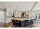 Spacious kitchen with a large granite island, pendant lighting, stainless steel appliances and hardwood floors at 1562 Asheforde Dr, Marietta, GA 30068