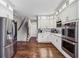 Modern kitchen featuring white cabinets, stainless steel appliances, hardwood floors and convenient access to the staircase at 1562 Asheforde Dr, Marietta, GA 30068