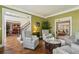 Cozy living room with olive green walls, hardwood floors, and comfortable seating at 1562 Asheforde Dr, Marietta, GA 30068