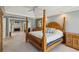 Spacious primary bedroom with a four-poster bed, fireplace, and ensuite bathroom at 1562 Asheforde Dr, Marietta, GA 30068
