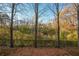A treelined backyard features a chain link fence at 2359 Castle Keep Way, Atlanta, GA 30316