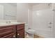 A bright bathroom features a shower-tub combination and dark wood vanity at 2359 Castle Keep Way, Atlanta, GA 30316