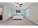 A bright bedroom with a ceiling fan and neutral carpet provides a relaxing haven at 2359 Castle Keep Way, Atlanta, GA 30316