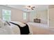 Spacious bedroom with soft carpet, neutral walls, ceiling fan, and bright natural light at 2359 Castle Keep Way, Atlanta, GA 30316