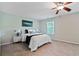 Comfortable bedroom with soft carpet, neutral walls, ceiling fan, and bright natural light at 2359 Castle Keep Way, Atlanta, GA 30316