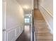 Inviting foyer with hardwood floors, wainscoting, and staircase leading to the upper level at 2359 Castle Keep Way, Atlanta, GA 30316