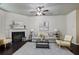 Inviting living room with neutral walls, a fireplace, ceiling fan, and an open concept at 2359 Castle Keep Way, Atlanta, GA 30316