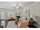 Bright living room features a ceiling fan, fireplace, neutral walls, and access to the backyard at 2359 Castle Keep Way, Atlanta, GA 30316