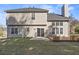 Backyard view of home with tan siding, deck, patio, and well-maintained lawn at 3940 Medlock Park Dr, Snellville, GA 30039