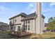 View of backyard, deck and beige siding on this two-story home at 3940 Medlock Park Dr, Snellville, GA 30039