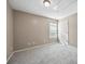 Neutral bedroom with gray carpet, white door, and window with blinds at 3940 Medlock Park Dr, Snellville, GA 30039