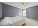 Spacious bedroom with ceiling fan and window with curtains at 3940 Medlock Park Dr, Snellville, GA 30039