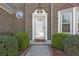 Elegant front entry with decorative trim, sidelight windows, and lush landscaping at 3940 Medlock Park Dr, Snellville, GA 30039