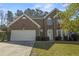 Charming two-story brick home with attached garage, manicured lawn, and decorative shutters at 3940 Medlock Park Dr, Snellville, GA 30039
