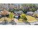 Well-maintained brick home with mature trees, manicured lawn and attached two-car garage in suburban neighborhood at 3940 Medlock Park Dr, Snellville, GA 30039
