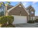 Spacious two-car garage with brick exterior and well-maintained landscaping at 3940 Medlock Park Dr, Snellville, GA 30039