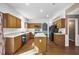 Bright kitchen featuring wood cabinets, white countertops, an island, and modern appliances at 3940 Medlock Park Dr, Snellville, GA 30039