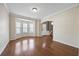 Sunlit living room with hardwood floors, bay window, and open entryway at 3940 Medlock Park Dr, Snellville, GA 30039