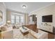Stylish living room with modern furniture, hardwood floors, and bright bay window at 3940 Medlock Park Dr, Snellville, GA 30039