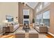 Living room with fireplace, tall ceilings, lots of light, hardwood floors, and updated furniture at 3940 Medlock Park Dr, Snellville, GA 30039