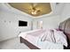 Main bedroom featuring a tray ceiling, plush carpet, and a large window at 3940 Medlock Park Dr, Snellville, GA 30039