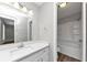 Well-lit bathroom featuring a shower-tub combo, modern fixtures, and a bright white vanity with a sink at 5307 Mountain Village Ct, Stone Mountain, GA 30083
