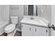 Traditional bathroom featuring a white toilet, vanity, mirror, and shower at 5307 Mountain Village Ct, Stone Mountain, GA 30083