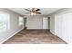This spacious bedroom features wood-look floors, a ceiling fan, and ample closet space with white doors at 5307 Mountain Village Ct, Stone Mountain, GA 30083