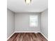Bedroom offering wood floors, gray walls, and a single window at 5307 Mountain Village Ct, Stone Mountain, GA 30083