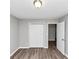 Bedroom with wood floors, gray walls, standard closet with white doors, and interior door at 5307 Mountain Village Ct, Stone Mountain, GA 30083