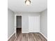 Bedroom with wood floors, gray walls, standard closet with white doors, and interior door at 5307 Mountain Village Ct, Stone Mountain, GA 30083