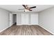 Large bedroom with wood-look floors, neutral paint, and bright natural light entering from windows at 5307 Mountain Village Ct, Stone Mountain, GA 30083