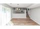 Open dining room showcasing a staircase, wood floors, neutral paint, and modern chandelier at 5307 Mountain Village Ct, Stone Mountain, GA 30083