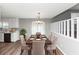 Dining area with elegant furniture, a modern light fixture, and access to the kitchen at 5307 Mountain Village Ct, Stone Mountain, GA 30083