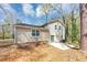Back exterior view of home featuring siding, roofline, walkout basement, and a concrete patio at 5307 Mountain Village Ct, Stone Mountain, GA 30083