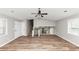 Open living area with new floors, stairs, a ceiling fan, and plenty of natural light at 5307 Mountain Village Ct, Stone Mountain, GA 30083