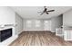 Bright living room with new floors, a fireplace, a ceiling fan, and plenty of natural light at 5307 Mountain Village Ct, Stone Mountain, GA 30083