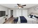 Modern bedroom with stylish decor, wood-look flooring, and a ceiling fan that brings comfort at 5307 Mountain Village Ct, Stone Mountain, GA 30083