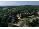 Aerial view of the property showing large mature trees and landscaping on a quiet street at 5347 Harbury Cv, Suwanee, GA 30024