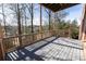 Back deck with a wood railing and ceiling offering tree views at 5347 Harbury Cv, Suwanee, GA 30024