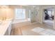 Bathroom features a soaking tub, a glass enclosed shower, and a double sink vanity at 5347 Harbury Cv, Suwanee, GA 30024