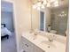 Bright bathroom features a double vanity, large mirror, and glass enclosed tiled shower at 5347 Harbury Cv, Suwanee, GA 30024