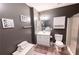 Bathroom featuring a single vanity, toilet, walk-in shower and decorative wall art at 5347 Harbury Cv, Suwanee, GA 30024