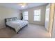 Bedroom features two windows with blinds, neutral walls, carpeted floor, and a bed at 5347 Harbury Cv, Suwanee, GA 30024
