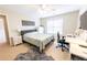 Inviting bedroom featuring a bed, desk, and bedside table, perfect for relaxation or work at 5347 Harbury Cv, Suwanee, GA 30024